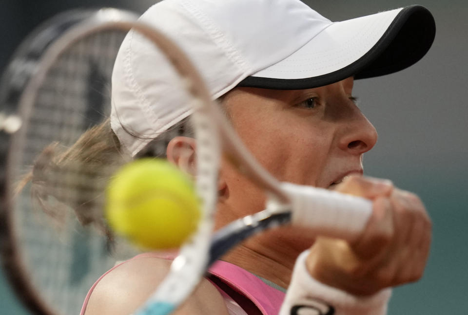 Poland's Iga Swiatek plays a return to Ukraine's Marta Kostyuk during their fourth round match on day 9, of the French Open tennis tournament at Roland Garros in Paris, France, Monday, June 7, 2021. (AP Photo/Christophe Ena)