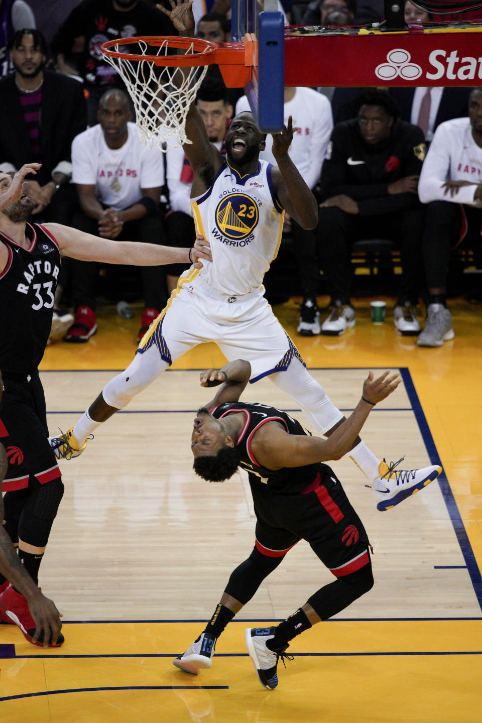 Golden State Warriors forward Draymond Green (23) shoots over Toronto Raptors guard Kyle Lowry during the first half of Game 3 of basketball's NBA Finals in Oakland, Calif., Wednesday, June 5, 2019. (AP Photo/Tony Avelar)