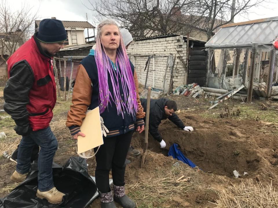 Oksana Brin, who lost her father in the bombardment of Chernihiv, oversees the exhumation of his body so that he can be buried at another site (Kim Sengupta)