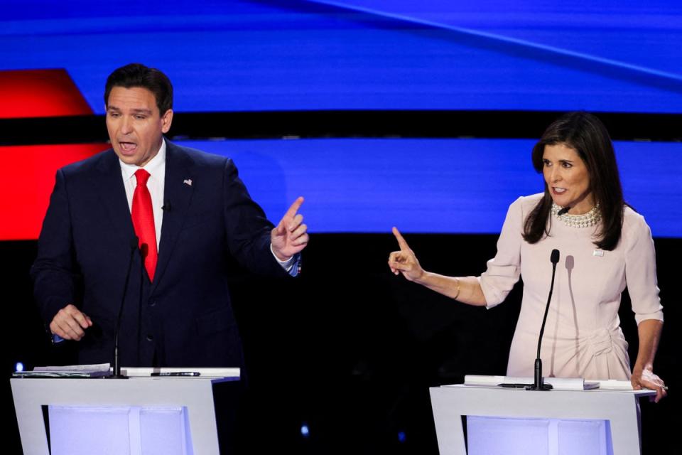 Republican candidates Ron DeSantis and Nikki Haley participate in the Republican presidential debate hosted by CNN at Drake University in Des Moines, Iowa, on Wednesday 10 January (Reuters)