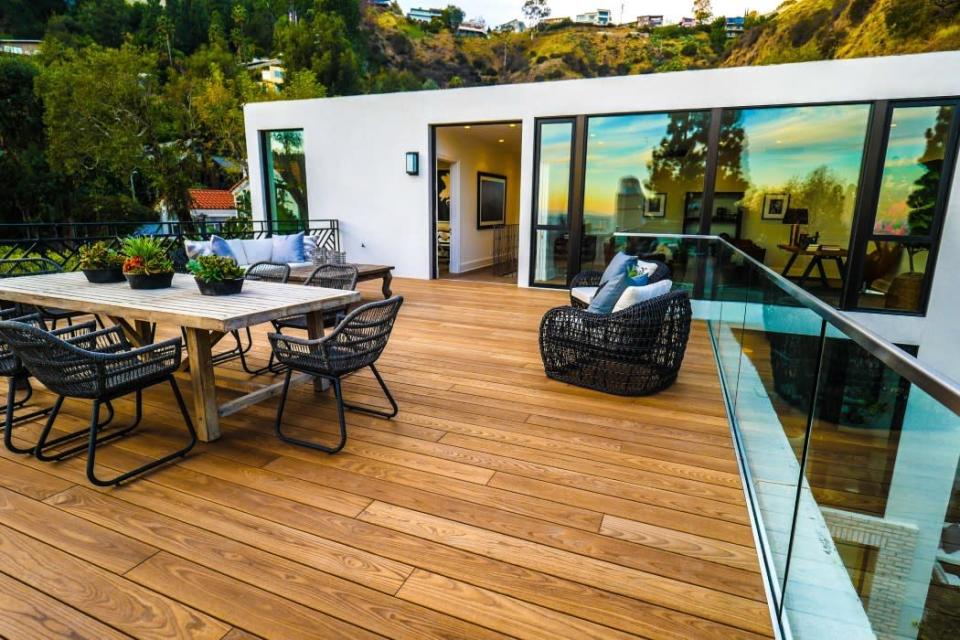 <p>The deck off the office. The room at left is a bedroom that’s being used as a Pilates studio. (Photo: <a href="http://bit.ly/1UCMKf2" rel="nofollow noopener" target="_blank" data-ylk="slk:Sotheby’s International Realty via Catherine Marcus;elm:context_link;itc:0;sec:content-canvas" class="link ">Sotheby’s International Realty via Catherine Marcus</a>, shot by Michael Izquierdo, Beverly Hills Aerial)</p>