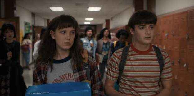 Eleven and Will walking through a school hallway