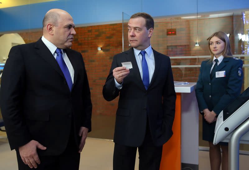 Russian Prime Minister Medvedev and head of the Federal Taxation Service Mishustin visit a tax office in Moscow