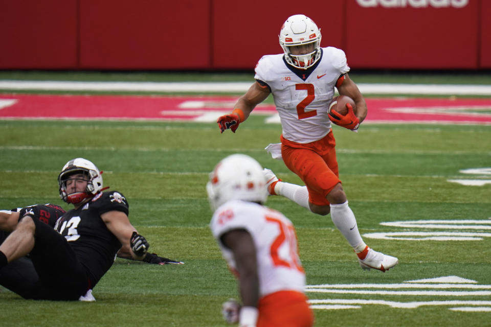 Illinois running back Chase Brown (2) runs past Nebraska linebacker JoJo Domann (13) during the first half of an NCAA college football game in Lincoln, Neb., Saturday, Nov. 21, 2020. (AP Photo/Nati Harnik)