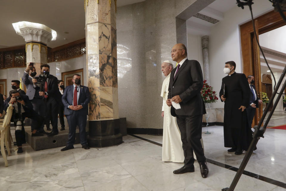 Pope Francis and Iraqi President Barham Salih enter Baghdad's Presidential Palace, Iraq, Friday, March 5, 2021. Pope Francis has arrived in Iraq to urge the country's dwindling number of Christians to stay put and help rebuild the country after years of war and persecution, brushing aside the coronavirus pandemic and security concerns. (AP Photo/Andrew Medichini)