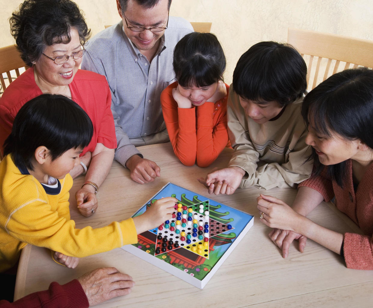 family playing board game (Tanya Constantine / Getty Images)