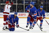 New York Rangers left wing Alexis Lafrenière (13) jumps over defenseman Erik Gustafsson's (56) stick during the first period in Game 2 of an NHL hockey Stanley Cup second-round playoff series against the Carolina Hurricanes, Tuesday, May 7, 2024, in New York. (AP Photo/Julia Nikhinson)