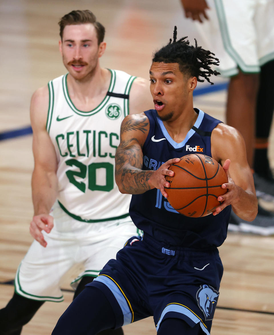 Memphis Grizzlies' Brandon Clarke (15) handles the ball as Boston Celtics' Gordon Hayward (20) defends during the second half of an NBA basketball game Tuesday, Aug. 11, 2020, in Lake Buena Vista, Fla. (AP Photo/Mike Ehrmann, Pool)