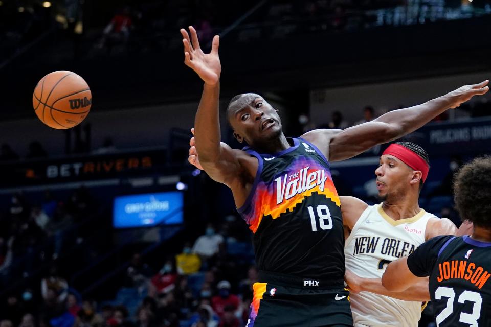 Phoenix Suns center Bismack Biyombo (18) battles for a loose ball with New Orleans Pelicans guard Josh Hart in the first half of an NBA basketball game in New Orleans, Tuesday, Jan. 4, 2022. (AP Photo/Gerald Herbert)