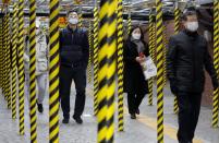 People wearing masks as a preventive measure against the coronavirus walk at a subway station in Seoul