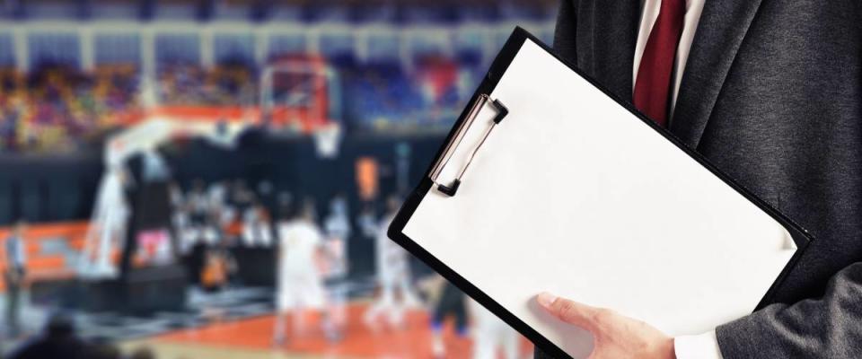 man hold report at basketball game