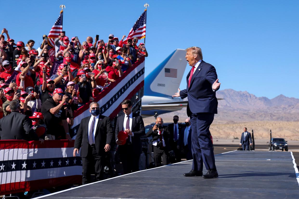 President Donald Trump gestures towards supporters as he arrives for a campaign rally at Laughlin/Bullhead International Airport in Bullhead City, Arizona, on Wednesday. (REUTERS)