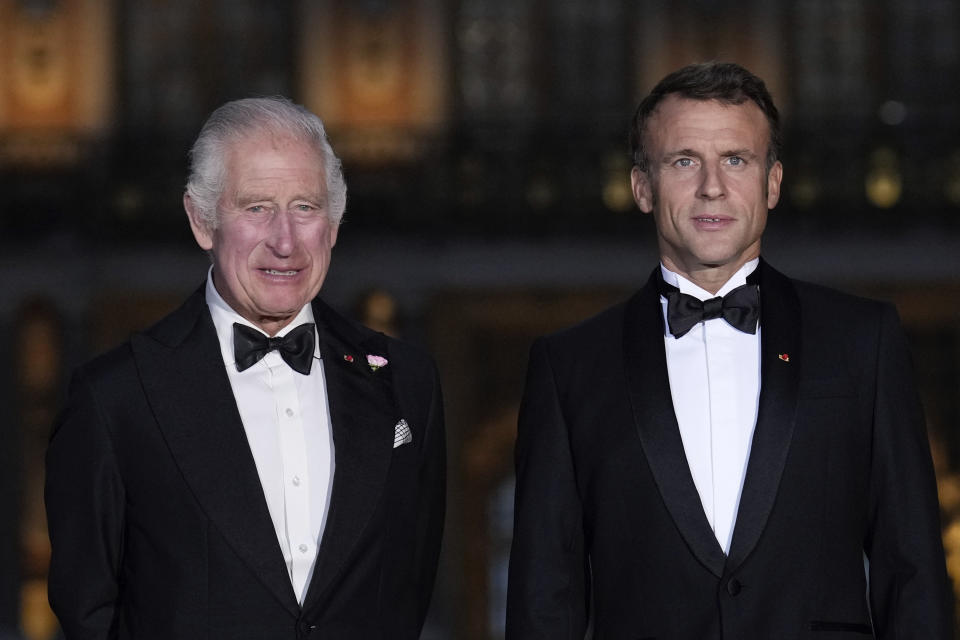 French President Emmanuel Macron, right, and Britain's King Charles III, arrive for a state dinner, at the Chateau de Versailles, west of Paris, Wednesday, Sept. 20, 2023. King Charles III of the United Kingdom starts a three-day state visit to France on Wednesday meant to highlight the friendship between the two nations with great pomp, after the trip was postponed in March amid widespread demonstrations against President Emmanuel Macron's pension changes. (AP Photo/Christophe Ena)