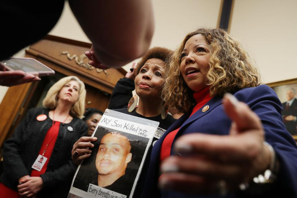 Mattie Scott, holding her son's photo, and Rep. Lucy McBath, D-Ga., at a hearing on gun violence legislation in 2019. Mcbath's son, Jordan Davis, was fatally shot at a Florida gas station in 2012 after the killer complained about the loud music coming from the teen’s car.