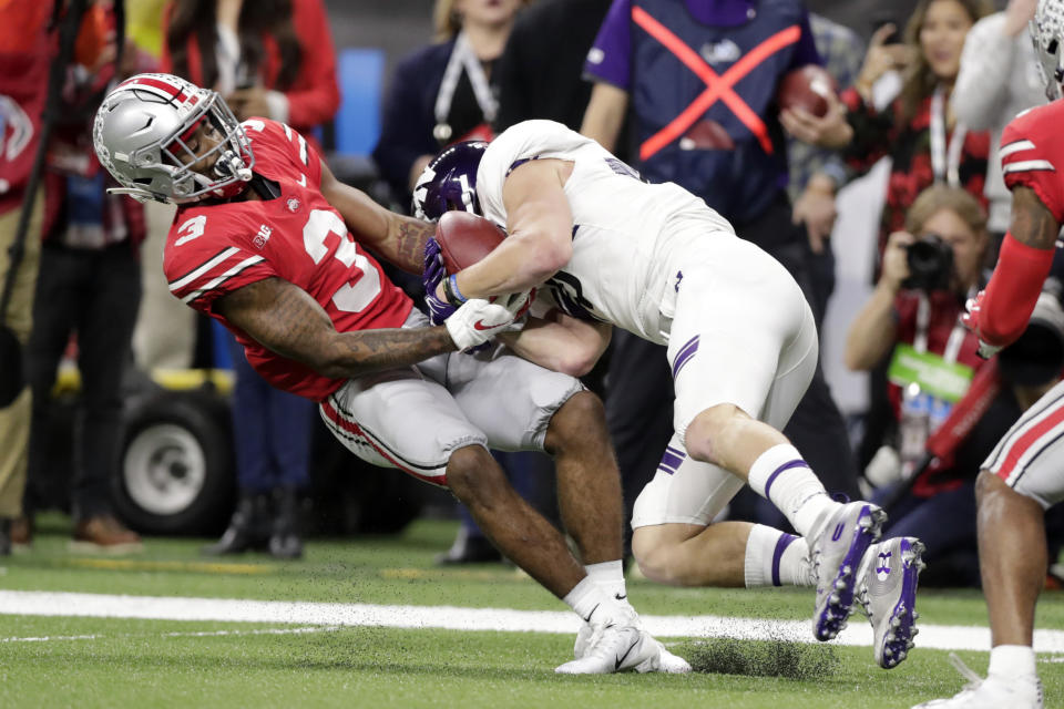Northwestern wide receiver Charlie Fessler begins to fumble as he is tackled by Ohio State cornerback Damon Arnette (3) during the second half of the Big Ten championship NCAA college football game, Saturday, Dec. 1, 2018, in Indianapolis. After review, Fessler was ruled down before the fumble and Northwestern maintained in position of the ball. (AP Photo/Michael Conroy)
