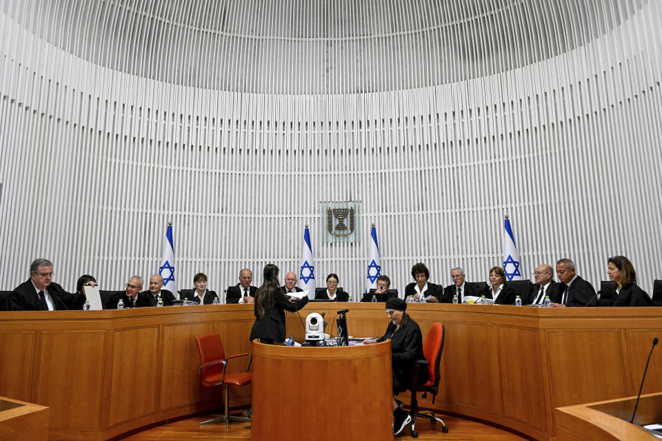 All 15 of Israel's Supreme Court justices appear for the first time in the country's history to look at the legality of Prime Minister Benjamin Netanyahu's contentious judicial overhaul, which the government pushed through parliament in July, in Jerusalem, Tuesday, Sept. 12, 2023. The divisive law, which cancels the court's ability to block government actions and appointments using the legal concept that they are "unreasonable," is the first piece of the wider government plan to weaken the Supreme Court. (Debbie Hill/Pool Photo via AP)