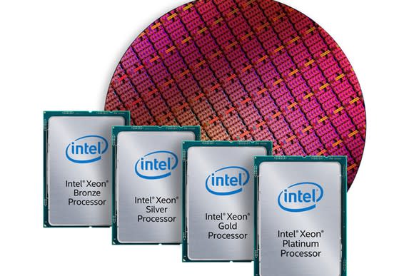 A wafer of Intel processors in the background with finished and packaged chips in the foreground.