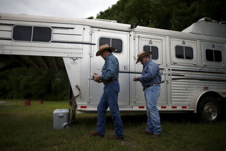 Wade Earp, 49, (L) and his husband Jonathan Suder, 25, from Dallas step out of their horse trailer at the International Gay Rodeo Association's Rodeo In the Rock in Little Rock, Arkansas, United States April 26, 2015. REUTERS/Lucy Nicholson