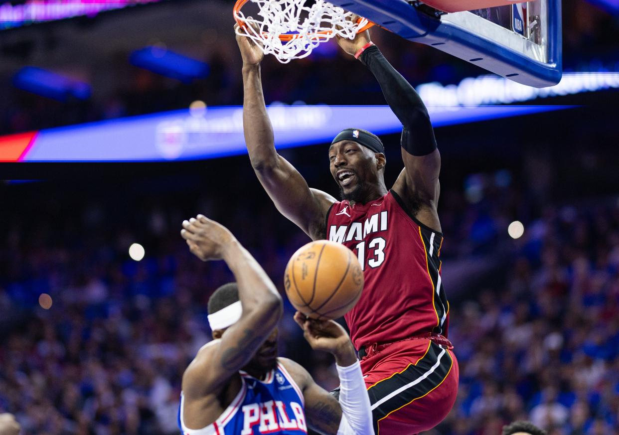 Heat center Bam Adebayo (13) dunks the ball over 76ers forward Paul Reed (44) during the second quarter of their NBA play-in tournament game at Wells Fargo Center in Philadelphia on April 17, 2024.