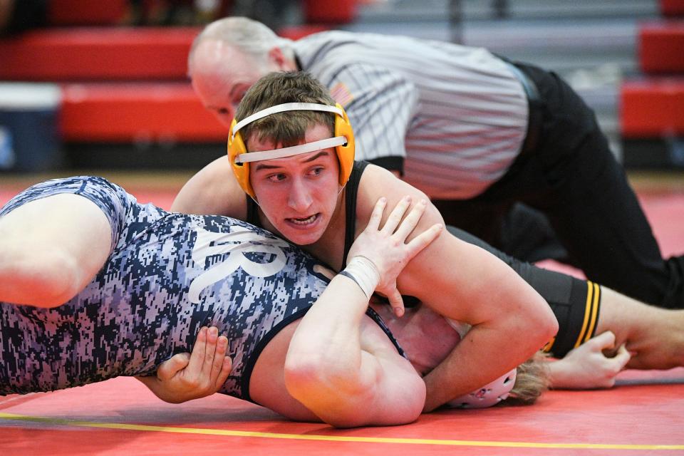 Southeast Polk's Carson Martinson, top, wrestles Rosevelt's Cole Norris at 160 pounds during a Class 3A district tournament at Carlisle on Saturday.