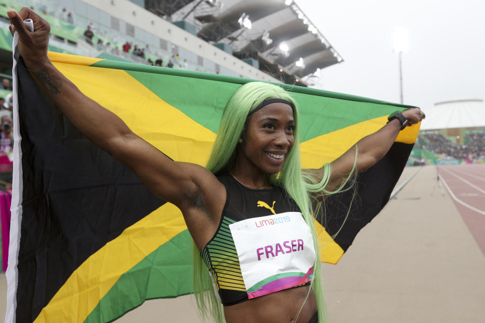 Shelly-Ann Fraser-Pryce of Jamaica celebrates winning the gold medal and setting and new Pan American record in the women's 200m final during the athletics at the Pan American Games in Lima, Peru, Friday, Aug. 9, 2019. (AP Photo/Martin Mejia)