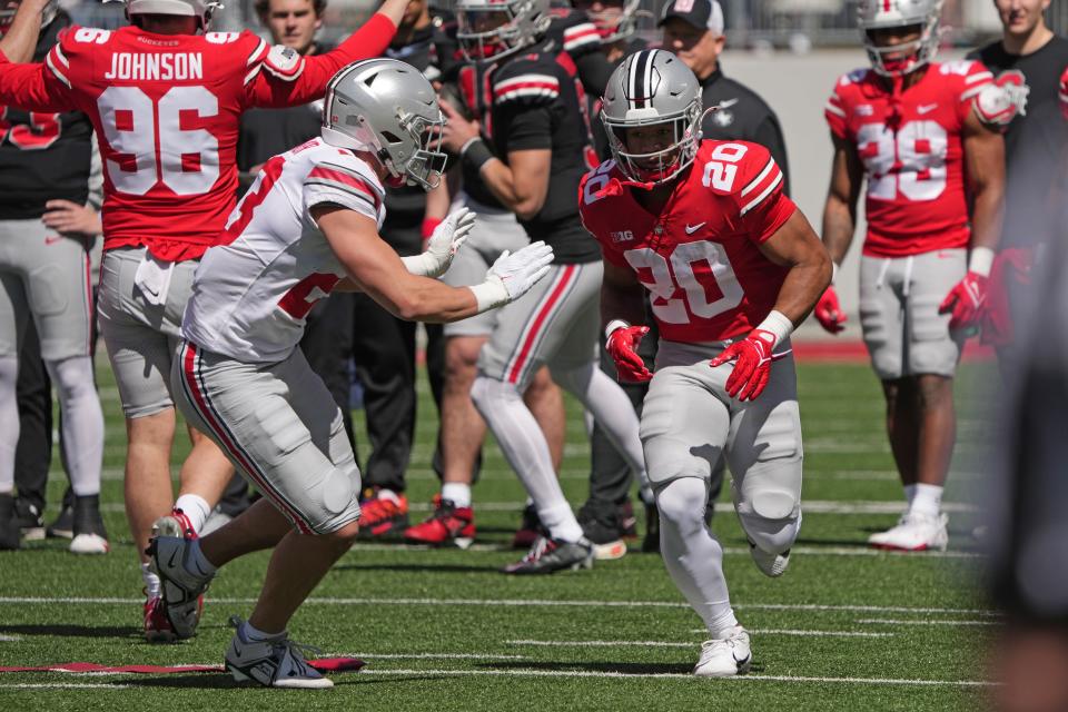 Apr 13, 2024; Columbus, OH, USA; Ohio State Buckeyes running back James Peoples (20) runs against Ohio State Buckeyes safety Brent ÒInkyÓ Jones (32) during warmups before the Ohio State football spring game at Ohio Stadium.