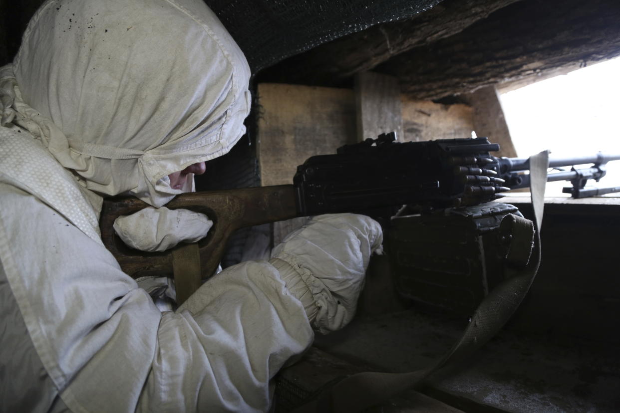 A serviceman in a trench.