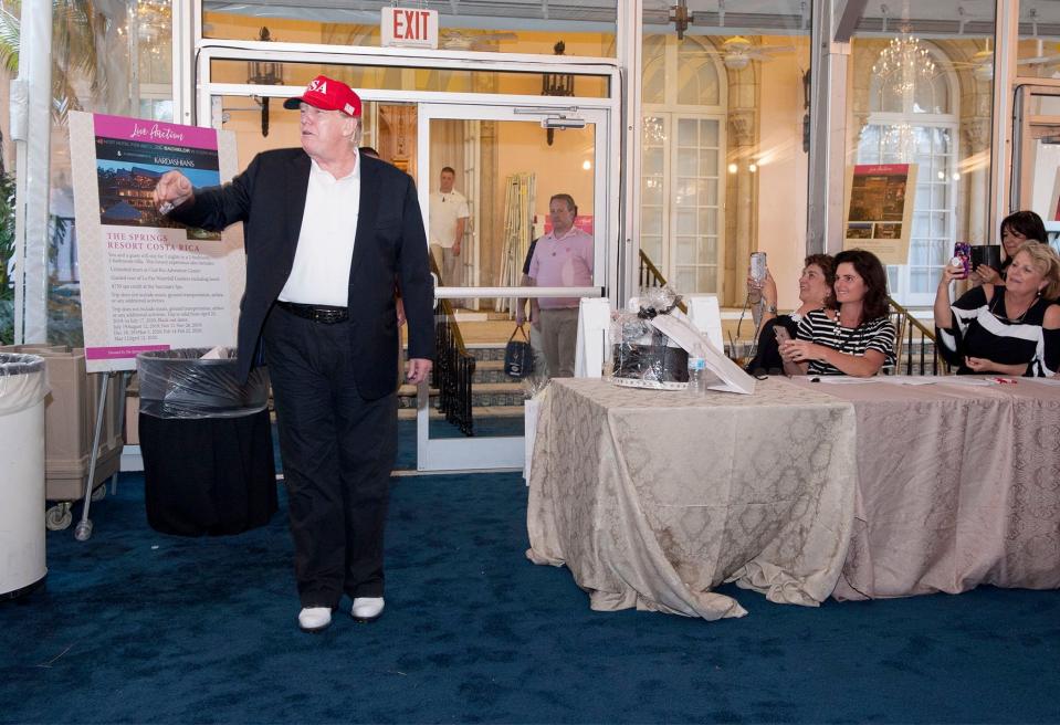 Then-President Donald Trump is seen stopping in to Big Dog Ranch Rescue's 6th annual Wine, Women and Shoes Lunch and Fashion Show at Mar-a-Lago on March 9, 2019 after Trump had returned from golfing.