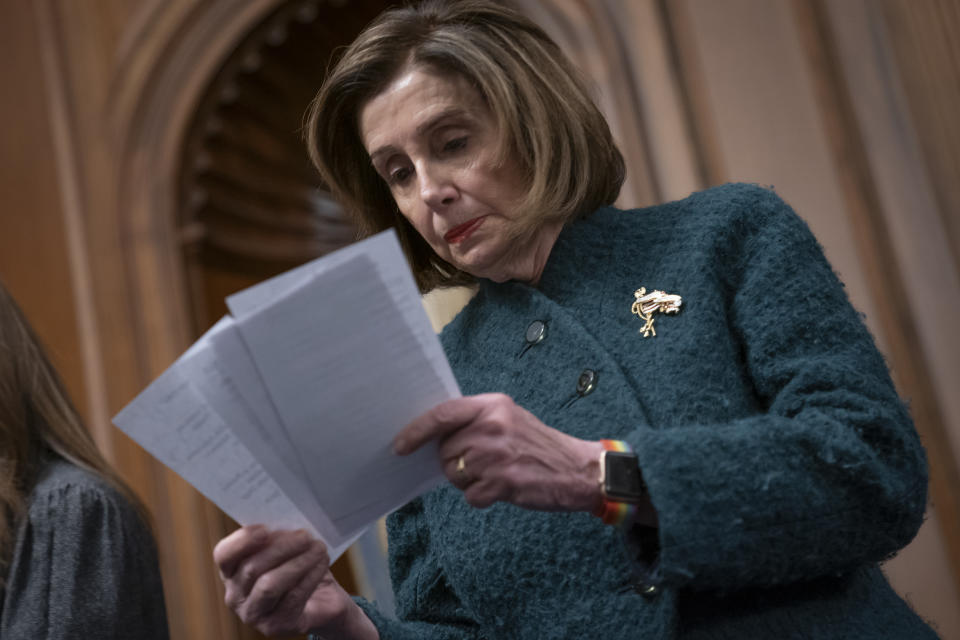 Speaker of the House Nancy Pelosi, D-Calif., reads a note handed to her from an aide as she attends a health care event at the Capitol in Washington, Wednesday, Dec. 11, 2019. (AP Photo/J. Scott Applewhite)