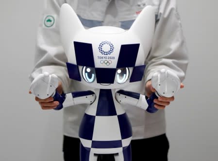 An employee of Toyota Motor Corp. demonstrates Tokyo 2020 mascot robot Miraitowa which will be used to support the Tokyo 2020 Olympic and Paralympic Games, during a press preview in Tokyo