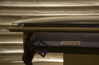 Hagit Maoz, curator of the Dead Sea Scrolls at the Shrine of the Book at the Israel Museum, makes final preparations following five months of closure due to the coronavirus pandemic, in Jerusalem, Tuesday, Aug. 11, 2020. The Israel Museum, the country's largest cultural institution, is returning the priceless Dead Sea scrolls and other treasured artworks to its galleries ahead of this week's reopening to the public. (AP Photo/Maya Alleruzzo)