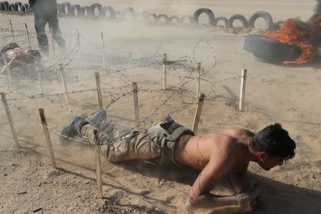 Sunni volunteers, who have joined the Abbas Fighting Division, take part in a field training in Kerbala, Iraq December 20, 2017. REUTERS/Thaier Al-Sudani