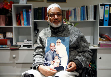 Al Noor mosque shooting survivor Farhid Ahmed poses with a photo of his wife Husna, who was killed in the attack, after an interview with Reuters in Christchurch, New Zealand March 18, 2019. REUTERS/Edgar Su