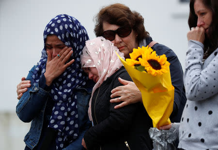 People lay flowers and gather to pay respects after Friday's shooting, outside the Masjid Al Noor in Christchurch, New Zealand March 18, 2019. REUTERS/Jorge Silva