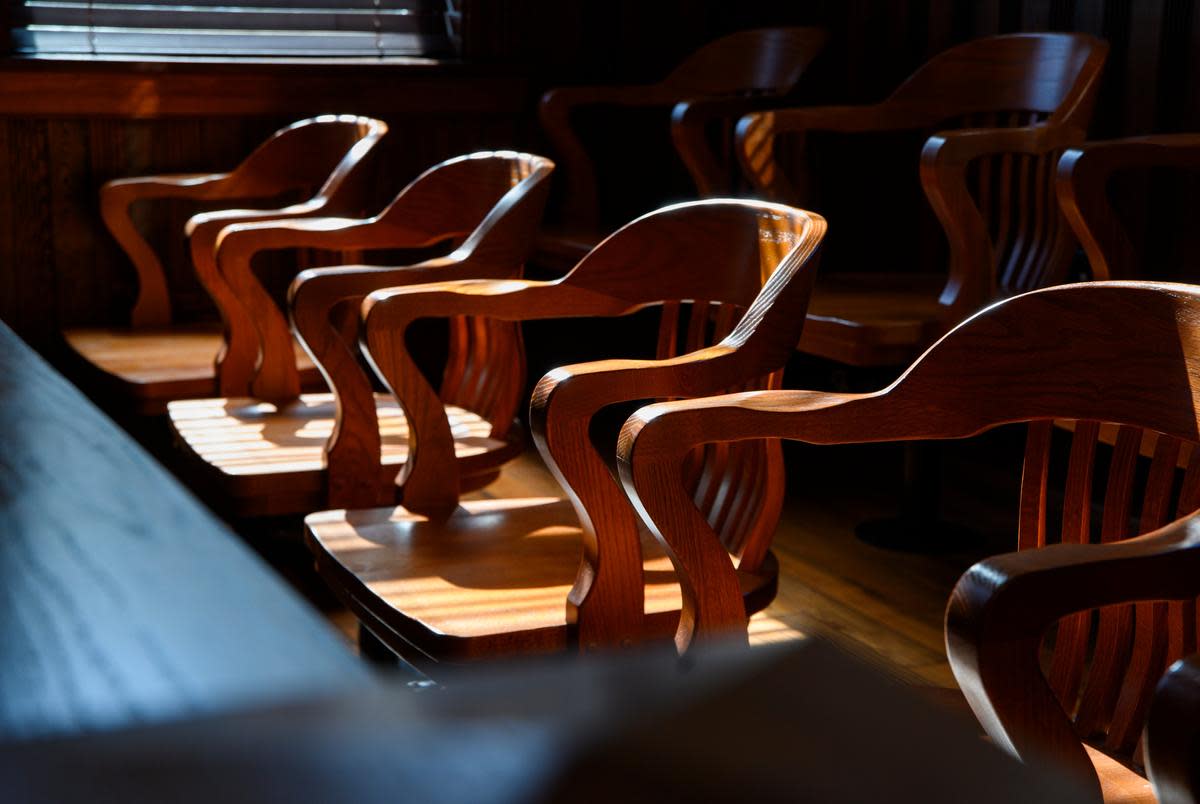 The courtroom jury box inside the Karnes County Courthouse is seen lit by window light Thursday, Aug. 17, 2023 in Karnes City. The courthouse was initially built in 1894 after the county seat was moved from nearby Helena to Karnes City and the structure was renovated from 2011 to 2018.