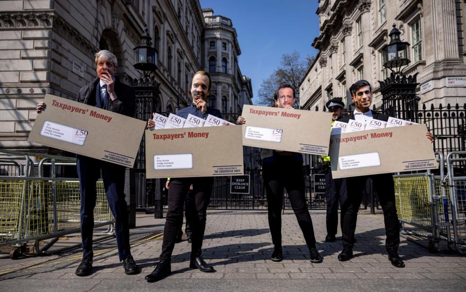 Say cheese: Campaigners dressed as ministers past and present outside Downing Street - Getty