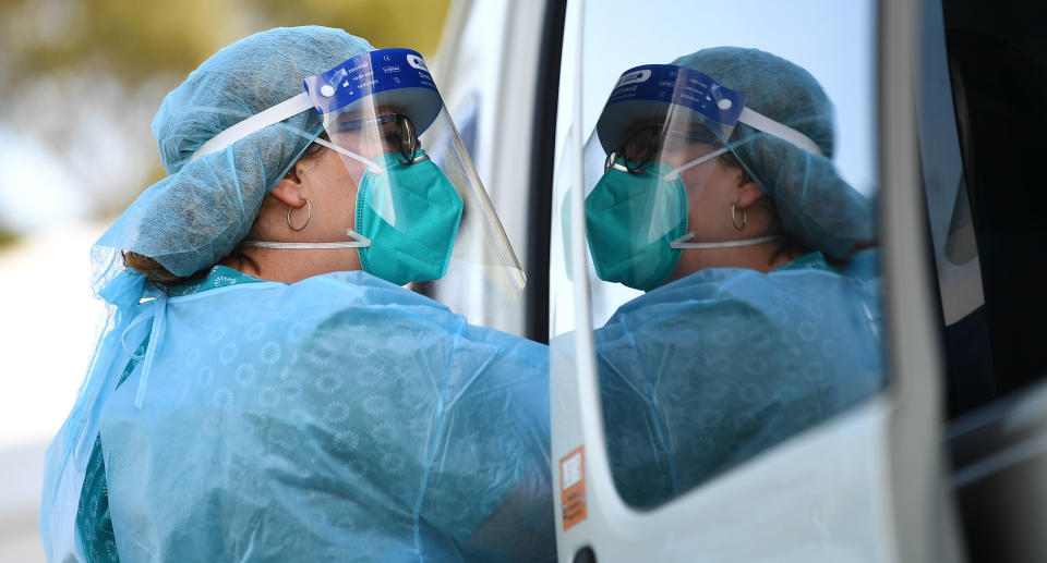 Pictured is a healthcare worker with a mask at a pop-up coronavirus testing facility in Clyde, Melbourne, Friday, September 18, 2020.