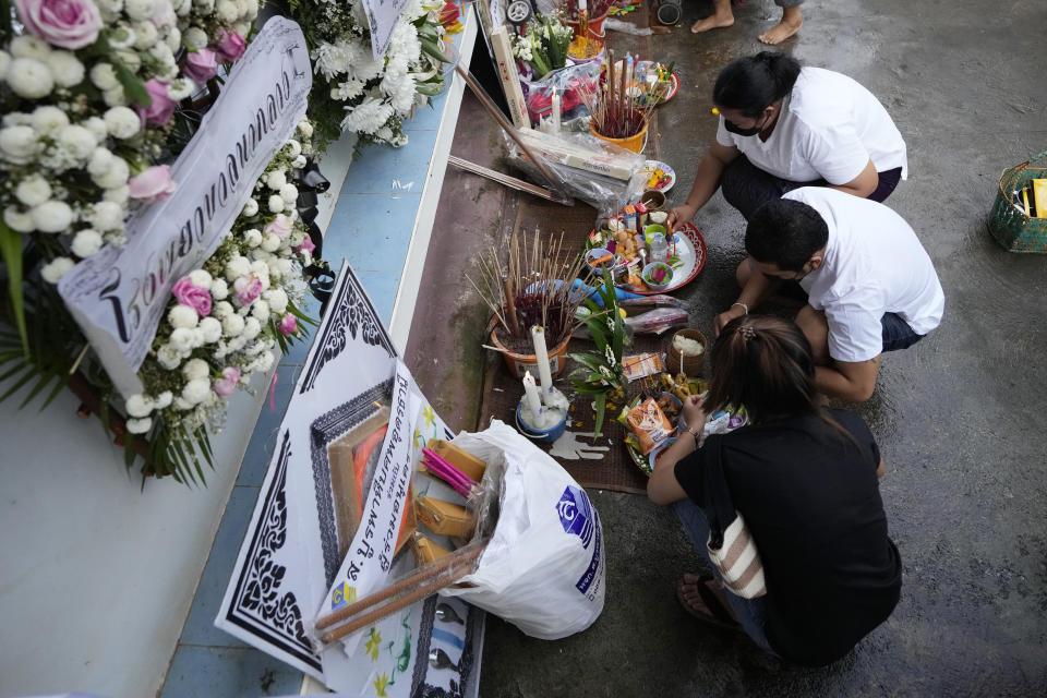 Relatives of the victims of a mass killing attack gather for a Buddhist ceremony Wat Rat Samakee temple in Uthai Sawan, northeastern Thailand, Monday, Oct. 10, 2022. A former police officer facing a drug charge burst through a locked door at a day care center in northeastern Thailand, killing dozens of preschoolers and teachers and then shooting more people as he fled. (AP Photo/Sakchai Lalit)