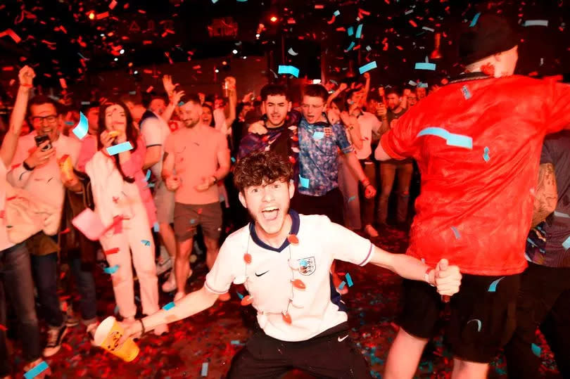 Fans celebrate the first England goal at the fanzone at Diecast