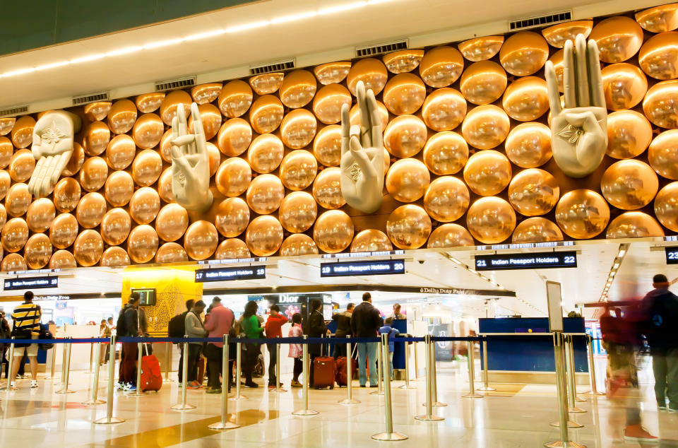 Delhi, India - January 21, 2015: Hands like the greeting symbols inside the International Airport of Delhi and crowd on January 21, 2015. Indira Gandhi International Airport is the 32th busiest in the world.