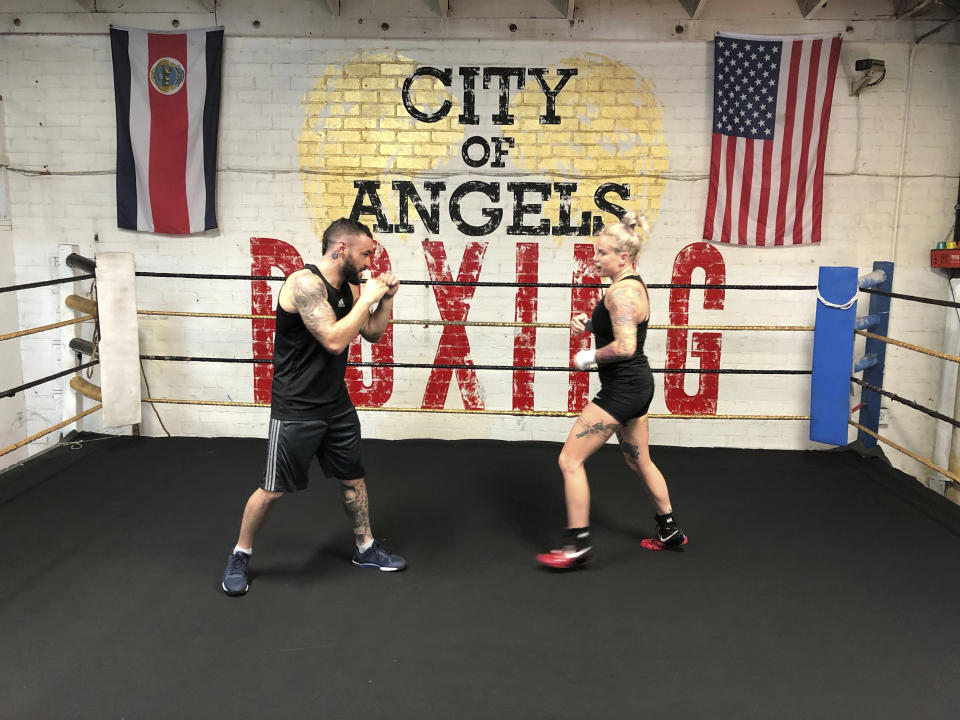 In this Thursday, Aug. 16, 2018 photo Bec Rawlings, right, of Australia, spars with her boyfriend Adrian Rodriguez, during a bare-knuckle training session at City of Angels Boxing Club in Los Angeles. Rawlings is a longtime UFC fighter who will fight on the second sanctioned bare-knuckle boxing show in the U.S. in over a century on Saturday, Aug. 25, in Biloxi, Miss. (AP Photo/Greg Beacham)