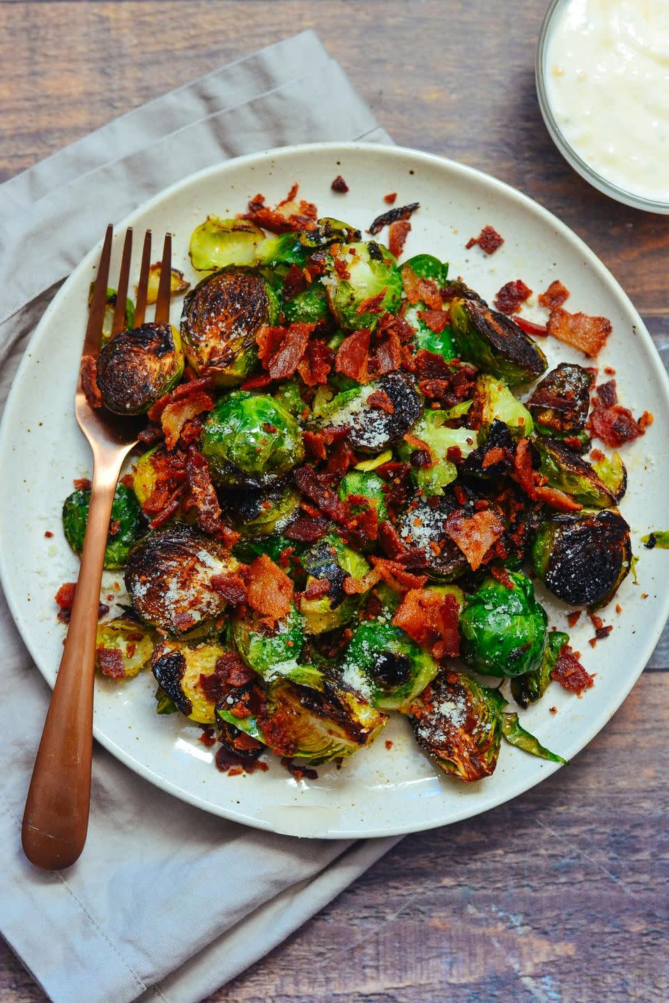 <p>This is one of <em>two</em> different Brussels sprouts recipes we're recommending, because they're both so different, and both so good! Here, generously crisped sprouts are paired with bacon and cheese, then dressed in a delicious aioli sauce.</p><p><strong>Get the recipe at <a href="https://cookswithsoul.com/pan-fried-brussels-sprouts-bacon-parmesan-garlic-aioli-sauce/" rel="nofollow noopener" target="_blank" data-ylk="slk:Cooks with Soul;elm:context_link;itc:0;sec:content-canvas" class="link ">Cooks with Soul</a>.</strong> </p>