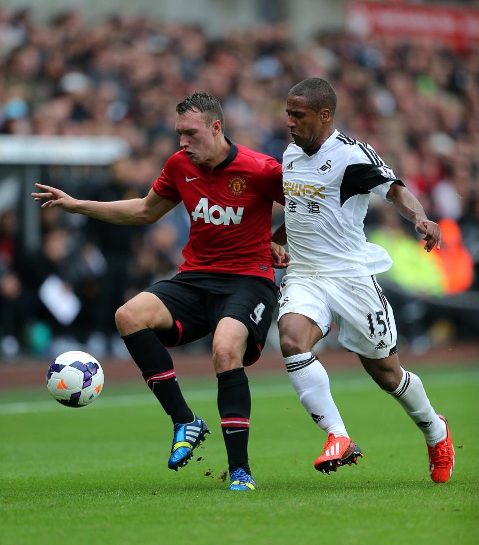 Manchester United's Phil Jones (left) and Swansea City's Ashley Williams battle for the ball.