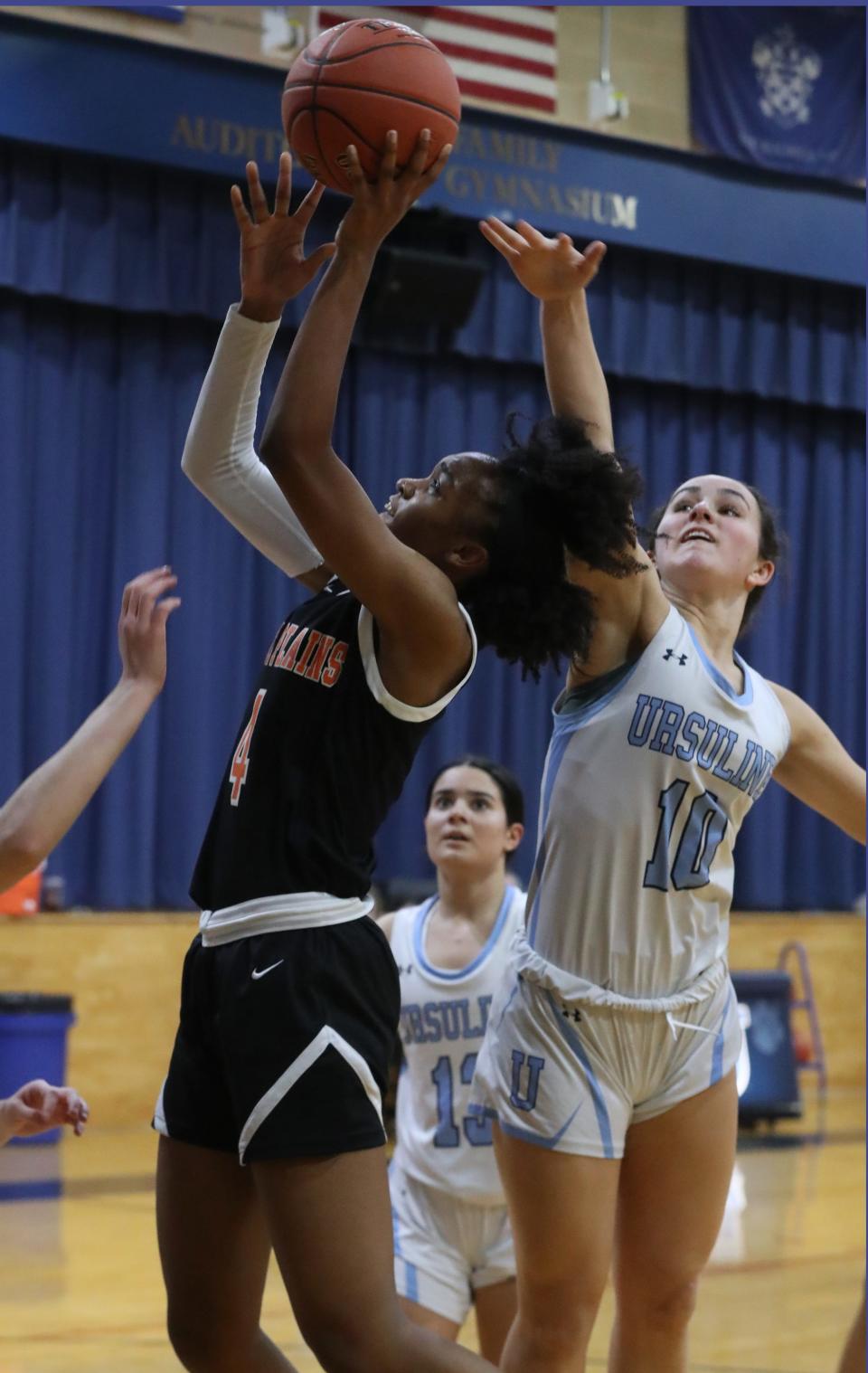 All-conference player Sequoia Layne of White Plains goes up for a shot as she's pressured by all-section player Sophie Nascimento of Ursuline during their game at Ursuline Jan. 30, 2023. White Plains won 50-44.