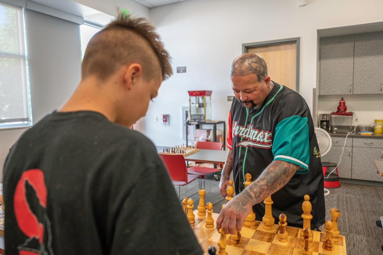 Hard Knox Gang Prevention and Intervention founder Mark Salazar, right, plays a game of chess with a youngster at the Patrick A. Lucero Library on Tuesday, May 17, 2022.