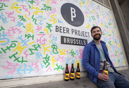 Sebastien Morvan, one of the founders of microbrewery Brussels Beer Project, displays bottles of beer called Babylone outside his office in central Brussels, April 14, 2015. REUTERS/Yves Herman