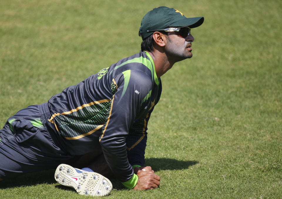 Pakistan captain Mohammad Hafeez does stretching exercises during a training session ahead of their ICC Twenty20 Cricket World Cup match against Bangladesh in Dhaka, Bangladesh, Saturday, March 29, 2014. (AP Photo/Aijaz Rahi)