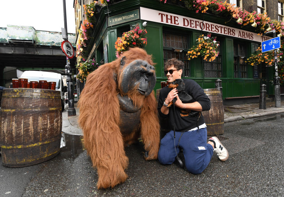 <p>An animatronic orangutan called Pongo with Louis, London and his dog, named Apache, outside Meridian's pop-up jungle themed pub, The 'Deforesters Arms' in London, to raise money for International Animal Rescue, a charity seeking to preserve and protect Orangutan habitats. Picture date: Tuesday October 5, 2021.</p>

