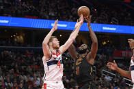 Cleveland Cavaliers center Andre Drummond (3) and Washington Wizards forward Davis Bertans (42) reach for the ball during the first half of an NBA basketball game Friday, Feb. 21, 2020, in Washington. (AP Photo/Nick Wass)
