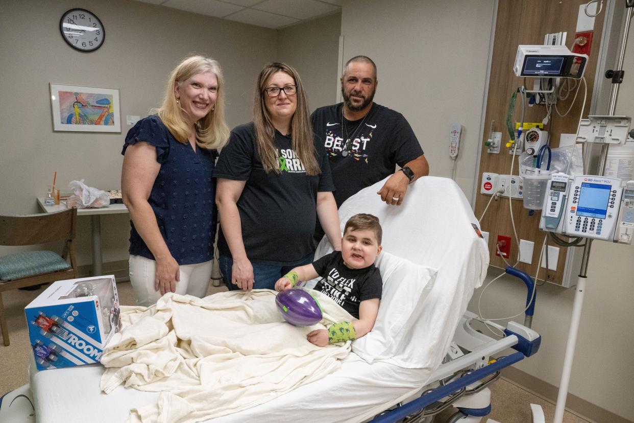 Six-year-old Vinny DeMando prepares for treatment for his Duchenne muscular dystrophy at Akron Children's Hospital. He is shown with Dr. Kathryn Mosher and his parents Jill and Michael DeMando.
